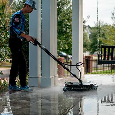 Power washing a front porch with concrete surface cleaner in Charlotte North Carolina