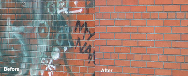 Before and after photo showing graffiti removal from a red brick wall, with the left side covered in spray paint and the right side fully cleaned.