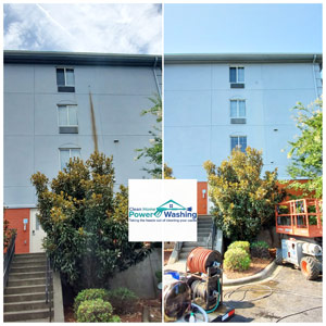 Before and after comparison of rust and stain removal on a multi-story building, featuring Clean Home Power Washing equipment in the foreground.